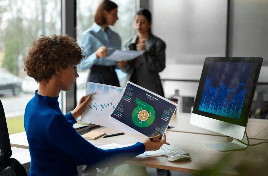 woman looking at a graph showing active participants and transaction diversity in tokenization programs